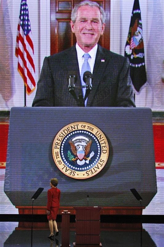 First lady Laura Bush walks off the stage as President Bush addresses the convention on a giant monitor Tuesday at the Republican National Convention in St. Paul, Minn.