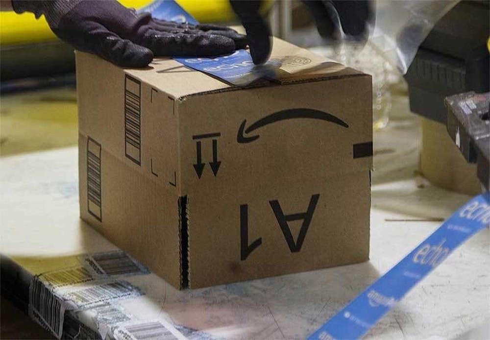 <p>An Amazon employee assembles a box April 7, 2020. Labor unions are slowly fading away as companies are getting wealthier.</p>
