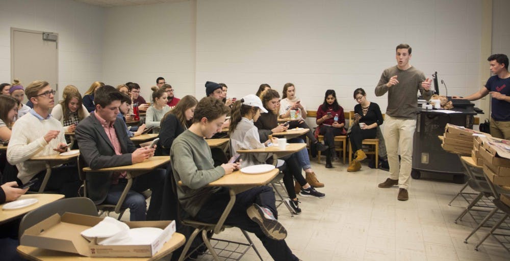 Student leaders of College Democrats interact students with phone  during their callout meeting Wednesday evening at the Psychology building.