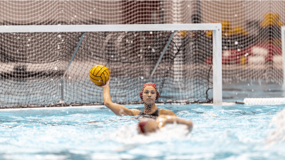 Graduate student Mary Askew throws the ball after stopping a goal April 8, 2023, at Counsilman Billingsley Aquatics Center in Bloomington. Indiana water polo concluded its regular season with a pair of wins over the weekend.
