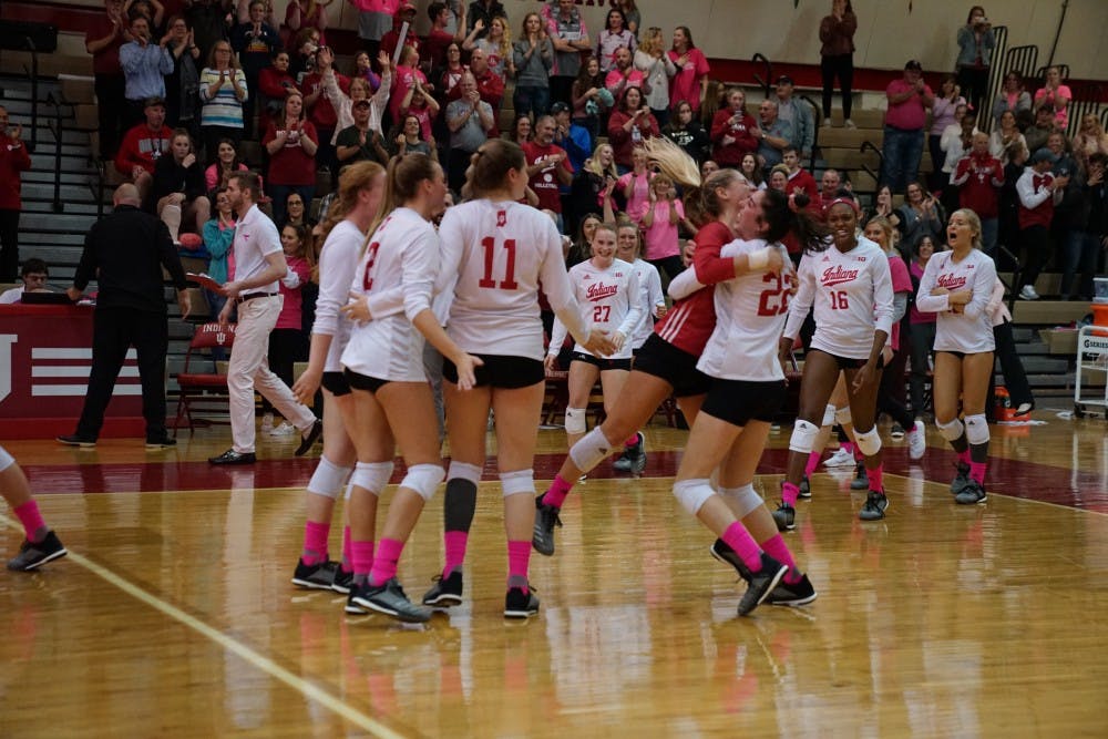 <p>Kamryn Malloy lifts Bayli Lebo up in the air in joy as the rest of the team rushes to celebrate its victory against Ohio State on Oct. 19 in University Gym. IU swept Ohio State, 3-0.</p>