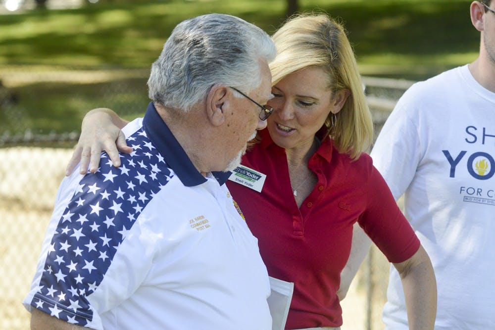 Bloomington Commander of Veteran’s Foreign Wars Joe Hardin and Congressional Candidate Shelli Yoder share greetings during the Democrat Picnic Sunday evening at Bryan Park. The event hosted families of Bloomington and democratic candidates with promises of free food and live entertainment.