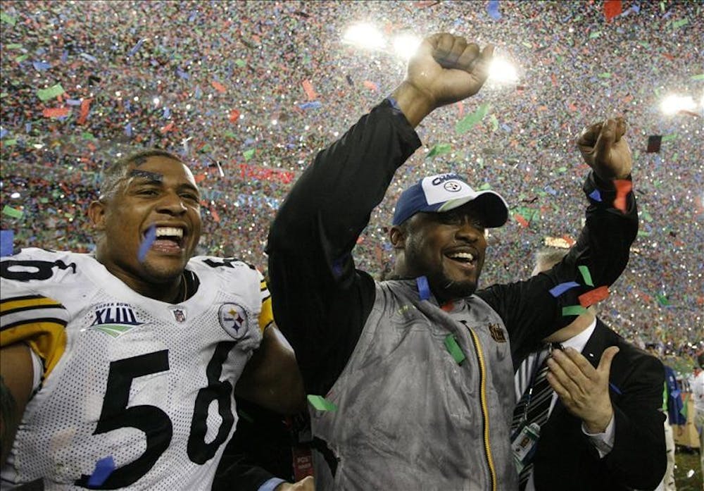 Pittsburgh Steelers head coach Mike Tomlin and linebacker LaMarr Woodley celebrate the team's 27-23 win over the Arizona Cardinals in the NFL Super Bowl XLIII football game, Sunday in Tampa, Fla.