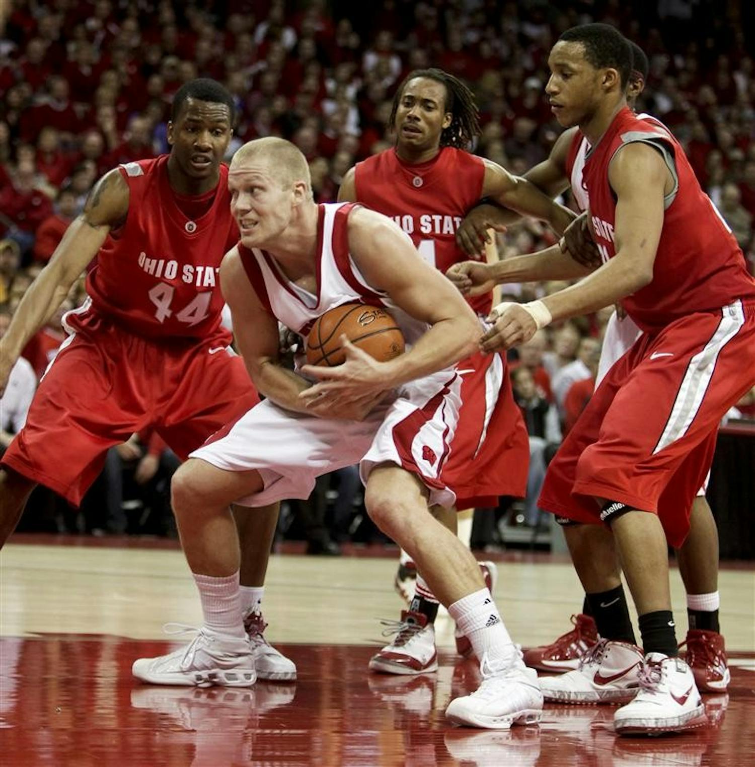 Wisconsin's Joe Krabbenhoft is surrounded by Ohio States' William Buford (44), P.J. Hill and Evan Turner, right,  after getting a offensive rebound during the second half of an NCAA college basketball game Saturday, Feb. 14, 2009, in Madison, Wis. Wisconsin won 55-50. 