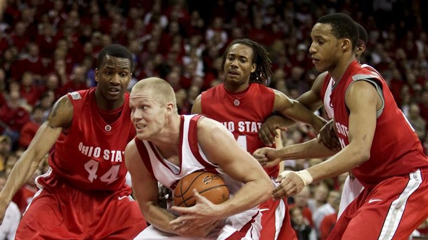Wisconsin's Joe Krabbenhoft is surrounded by Ohio States' William Buford (44), P.J. Hill and Evan Turner, right,  after getting a offensive rebound during the second half of an NCAA college basketball game Saturday, Feb. 14, 2009, in Madison, Wis. Wisconsin won 55-50. 