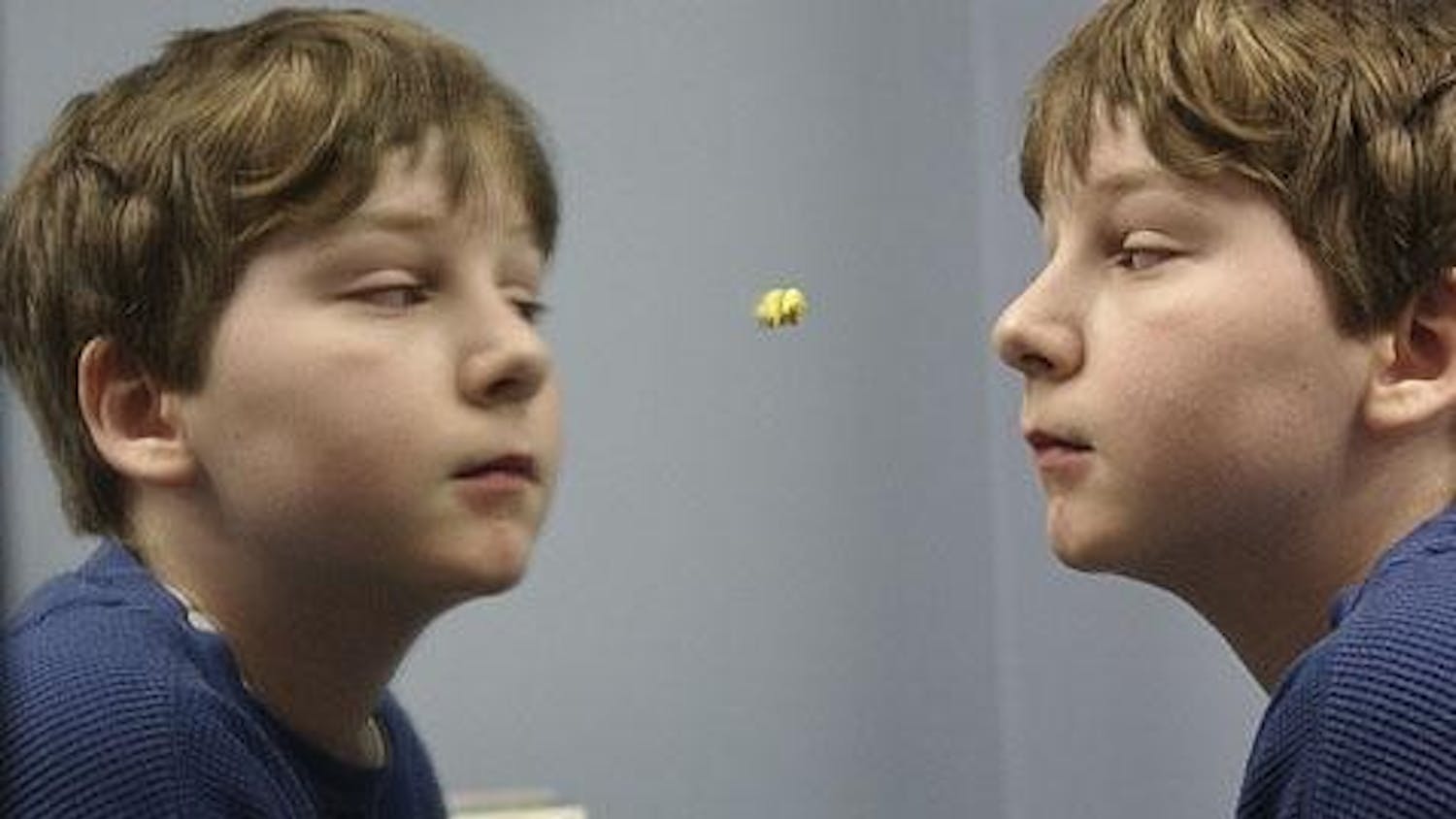Ezra Robinson, 11, engages himself in the mirror during a speech therapy session. Ezra began exhibiting signs of autism when he was 2 years old and has since been diagnosed in the middle of the autism spectrum.