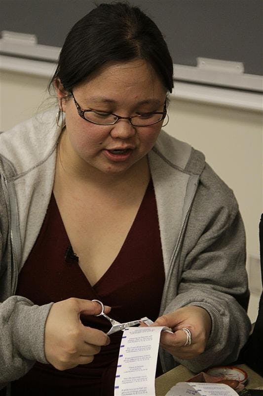 New York Times reporter Jennifer 8. Lee cuts up fortunes to place in signed books before her speech Thursday evening in Ernie Pyle Hall. Lee spoke about how Chinese food has helped shape American culture.
