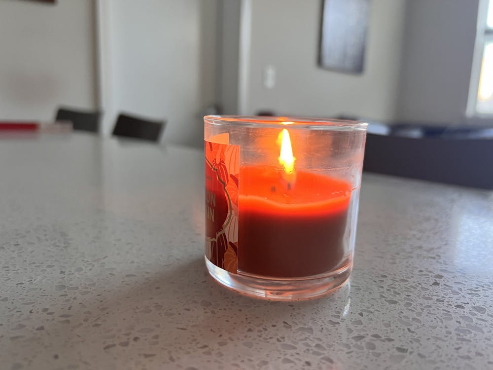 A candle burns in an off-campus apartment Oct. 1, 2022. 