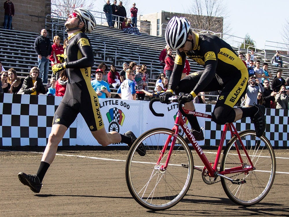Black Key Bulls riders Charlie Hammon and Spencer Brauchla exchange bike during the qualification on Saturday at Bill Armstrong Stadium. BKB will start the Little 500 race from the third place position with time 2:19.958.
