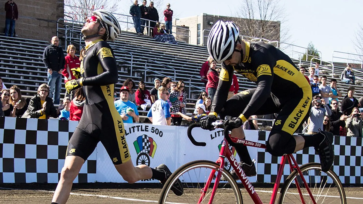 Black Key Bulls riders Charlie Hammon and Spencer Brauchla exchange bike during the qualification on Saturday at Bill Armstrong Stadium. BKB will start the Little 500 race from the third place position with time 2:19.958.