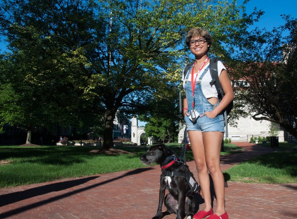 Kyla Jackson is on her way to her classroom with her service dog Caper on Monday morning outside Franklin Hall. She was excited about her first day of school.