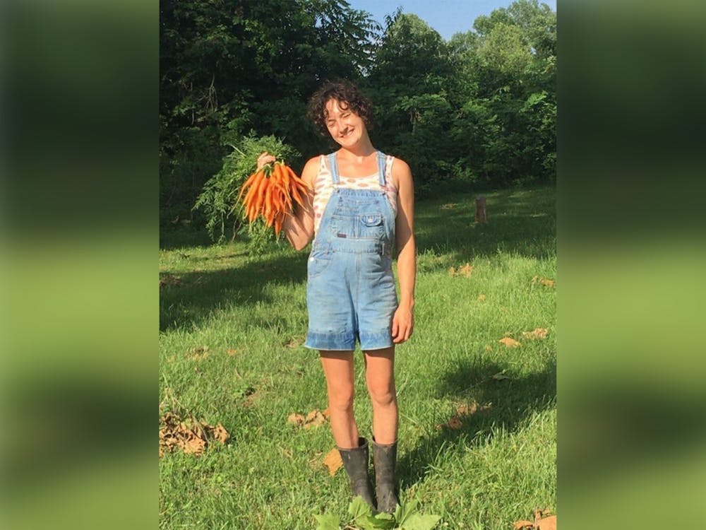 Maggie Gates posing with carrots while working at Common Home Farm in summer 2021. Gates was granted conditional bond on March 31, 2023.