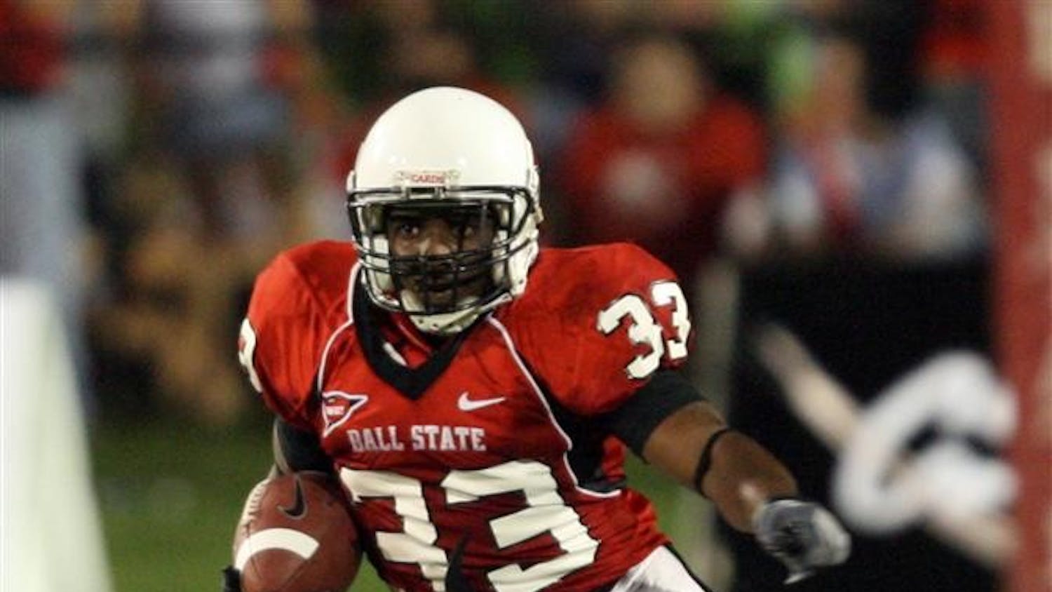Ball State's MiQuale Lewis runs with the ball in the second half of the NCAA football game against Navy on Friday in Muncie, Ind. Ball State won 35-23.