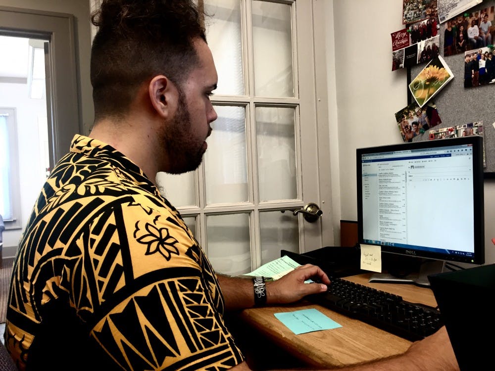 Dillon Tautunu-Smith, an Asian Culture Center member, creates the schedules Thursday, for the new tutors in the center's office. These volunteers help tutor students who need assistance with speaking English, dealing with cultural differences with others, and assisting anyone who needs guidance. 
