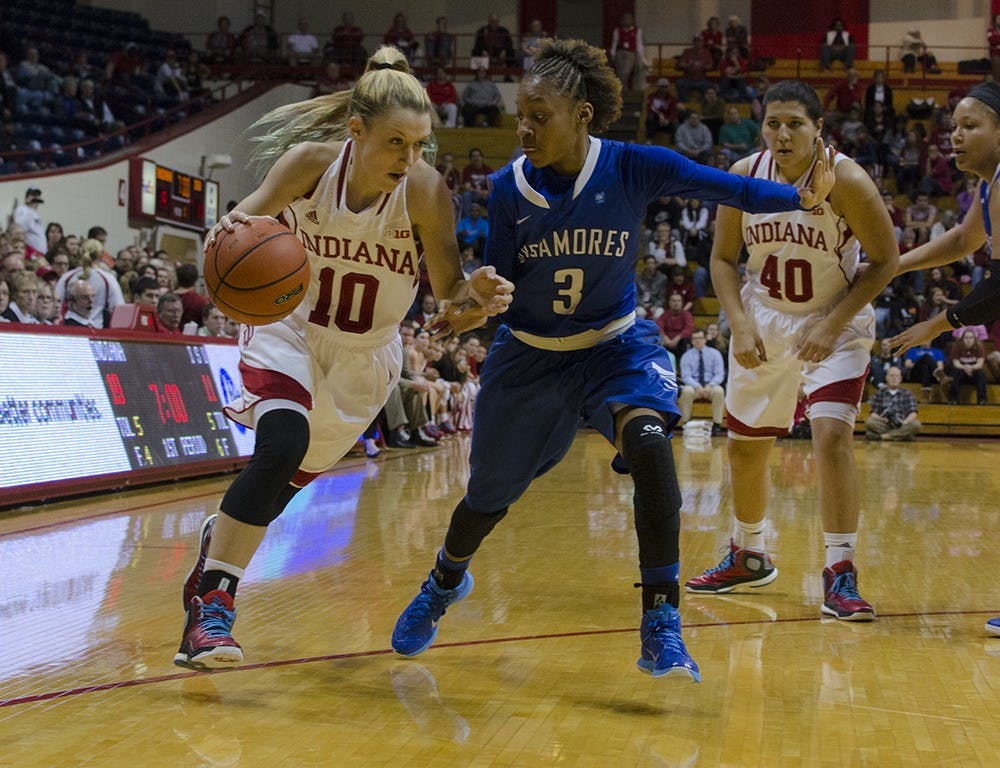 Sophomore guard Taylor Agler dribbles around an Indiana State defender during the Hoosier's game on Sunday. Indiana lost its first game of the season 65-61 in overtime.