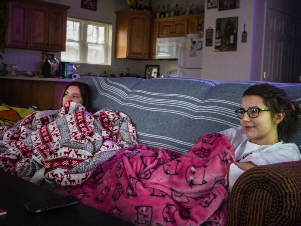 Juniors and roommates Skye Huffman, left, and Haley Leffler sit on their couch Jan. 12 in their off-campus house. If you decide to live with others, it’s important to find people who you get along with. 
