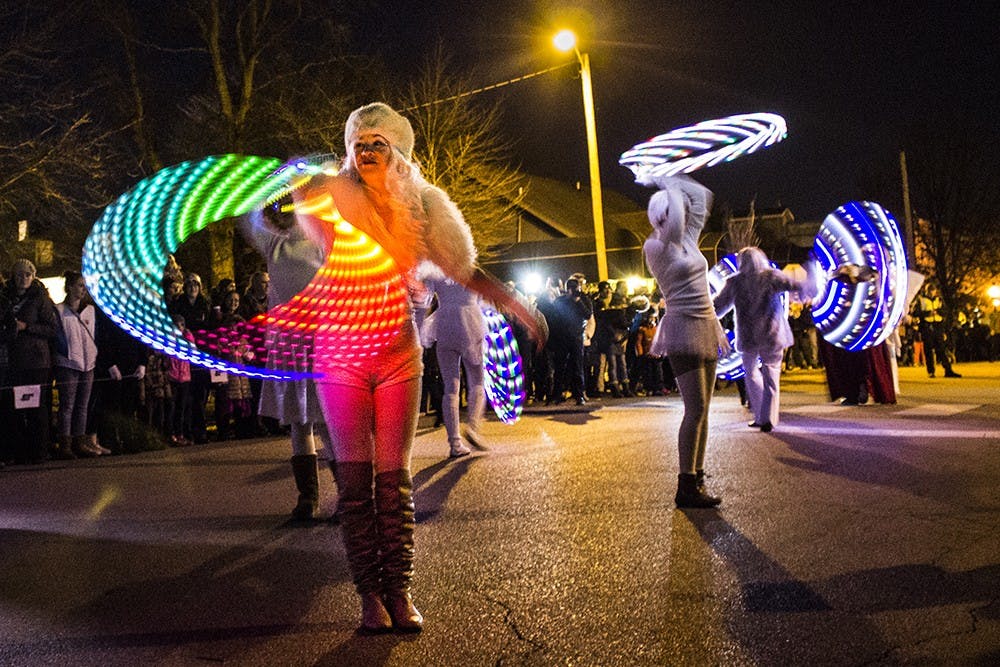 Christmas angels walk at the beginning of the Krampus parade in downtown Bloomington on Saturday evening.