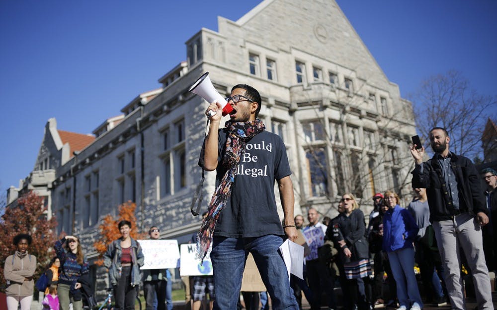Willy Palomo yells into a megaphone while leading a group of students in a chant during a rally for a Sanctuary Campus Wednesday at Sample Gates. Palomo is with the UndocuHoosier Alliance and was rallying to bring awareness to isues facing undocumented students on IU's campus. "Hoosier Promise," he yelled. "Is a lie," the crowd followed up. "Only true," he yelled out again. "If you're white," the crowd finished. 