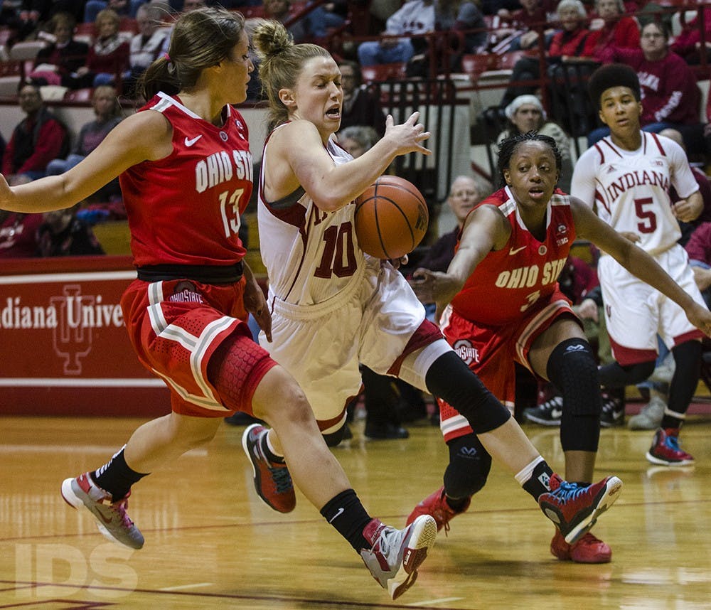 Sophomore guard Taylor Agler tries to get past a Buckeye double team to shoot a layup on Thursday at Assembly Hall. Indiana lost 103-49 and will play its next home game against Wisconsin on Saturday. 