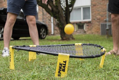 Students play Spikeball on Sept. 6 in a backyard in Bloomington. Spikeball tournaments across the country were canceled as a result of the coronavirus pandemic.