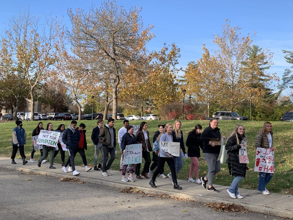 <p>Students march on Nov. 19, 2021, along North Jordan Avenue in support of survivors of sexual assault.</p>