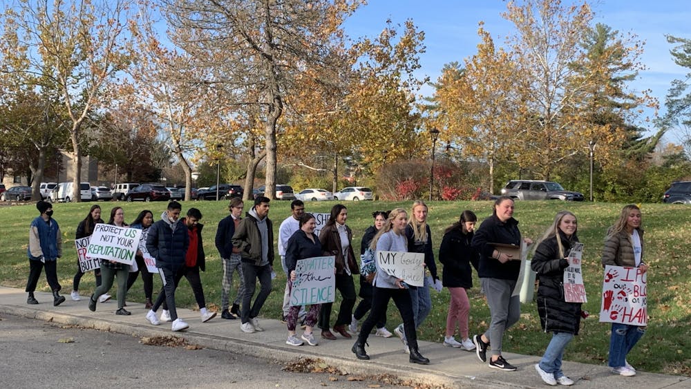 Students march on Nov. 19, 2021, along North Jordan Avenue in support of survivors of sexual assault.