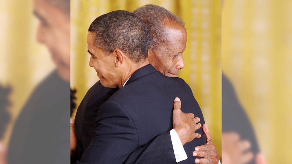 President Barack Obama awards the Presidential Medal of Freedom to Academy Award-winning actor Sidney Poitier during a ceremony at the White House in Washington D.C., on Aug. 12, 2009. Actor Sidney Poitier opened doors for the future of African American triumphs in black and white cinema during his career and after his death. 