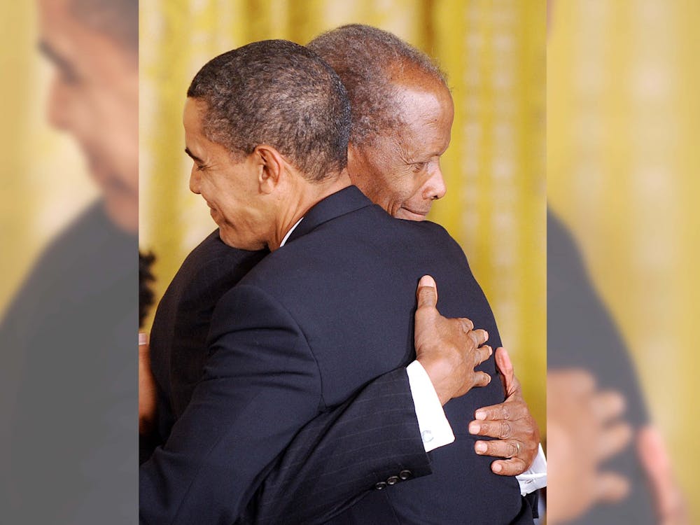 President Barack Obama awards the Presidential Medal of Freedom to Academy Award-winning actor Sidney Poitier during a ceremony at the White House in Washington D.C., on Aug. 12, 2009. Actor Sidney Poitier opened doors for the future of African American triumphs in black and white cinema during his career and after his death. 