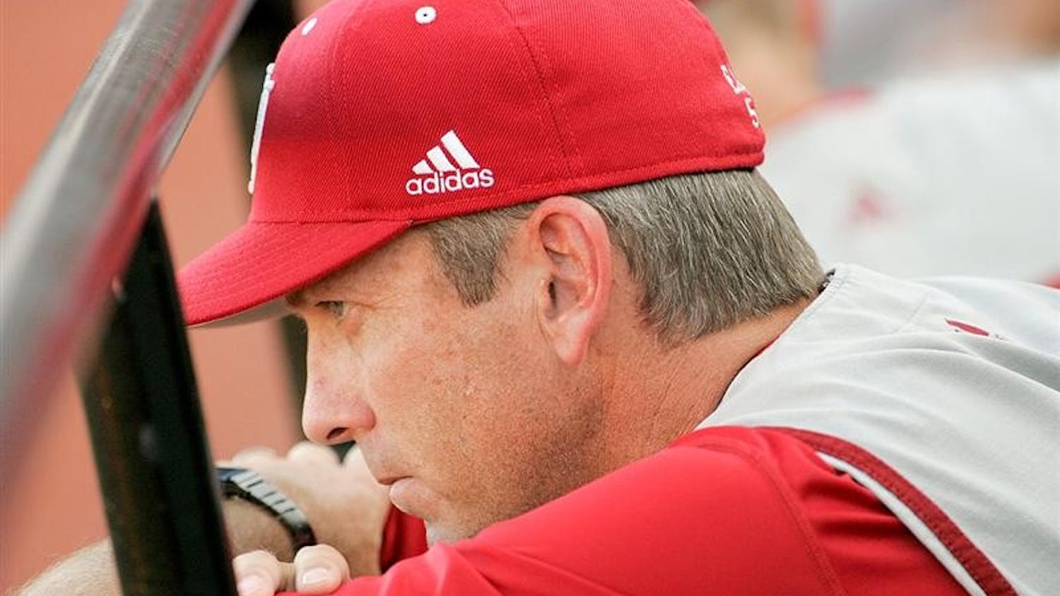 IU head baseball coach Tracy Smith watches the Hoosiers 8-2 loss to Louisville unfold Friday evening at Patterson Stadium. Hoosier pitchers gave up only seven hits but three errors leading to four unearned runs for the Cardinals.