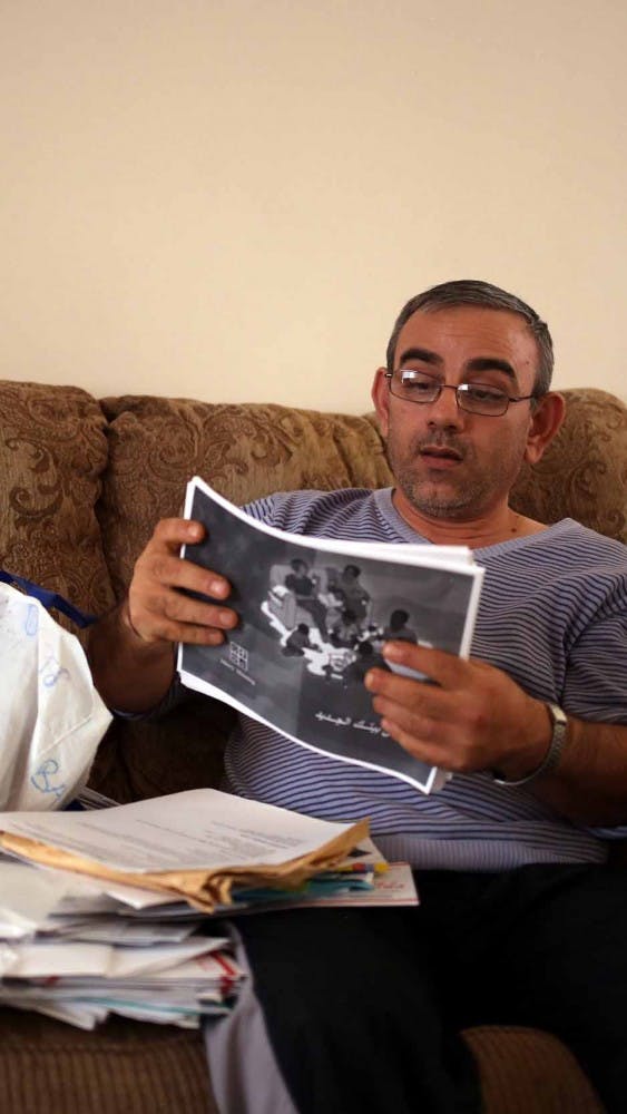 Marwan peruses through his bag of refugee documents - dozens of papers that overflow onto his lap that document his pathway to creating a new life for his family. 