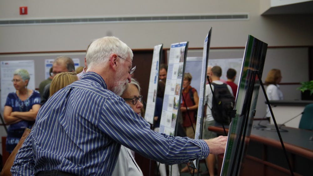 Bloomington residents review the draft of the city's new transportation plan that was presented for public comment Thursday night at City Hall.