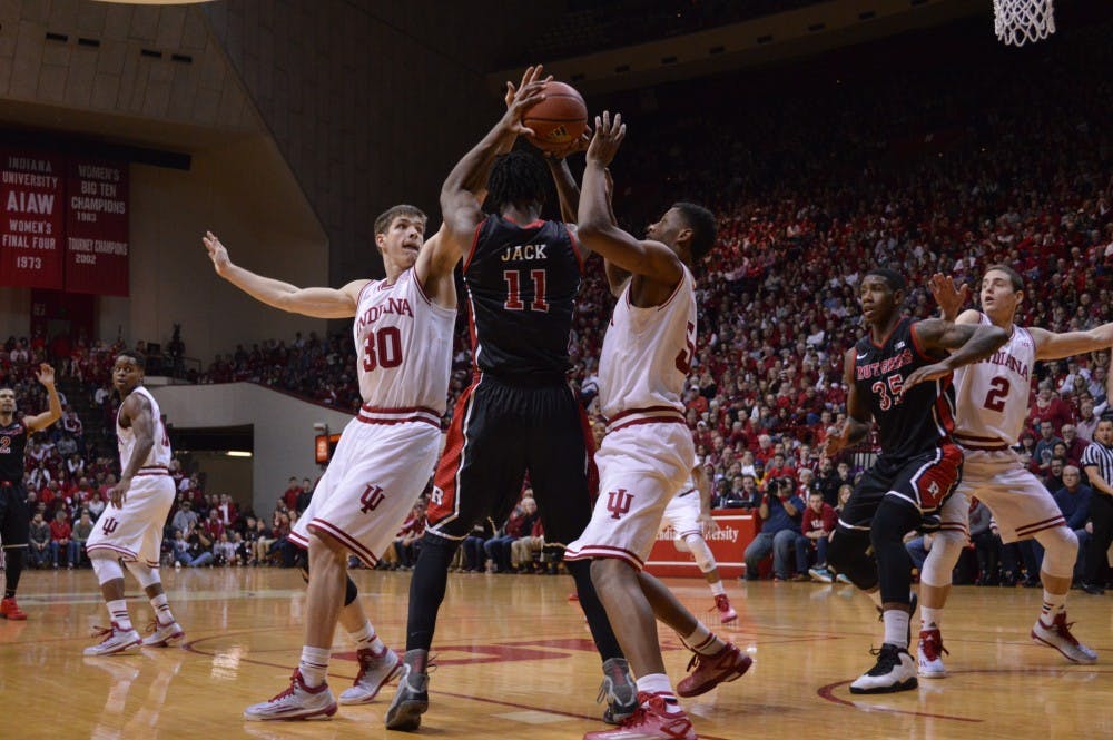 Sophomore forwards Collin Hartman and Troy Williams double team a Rutgers player Saturday at Assembly Hall.