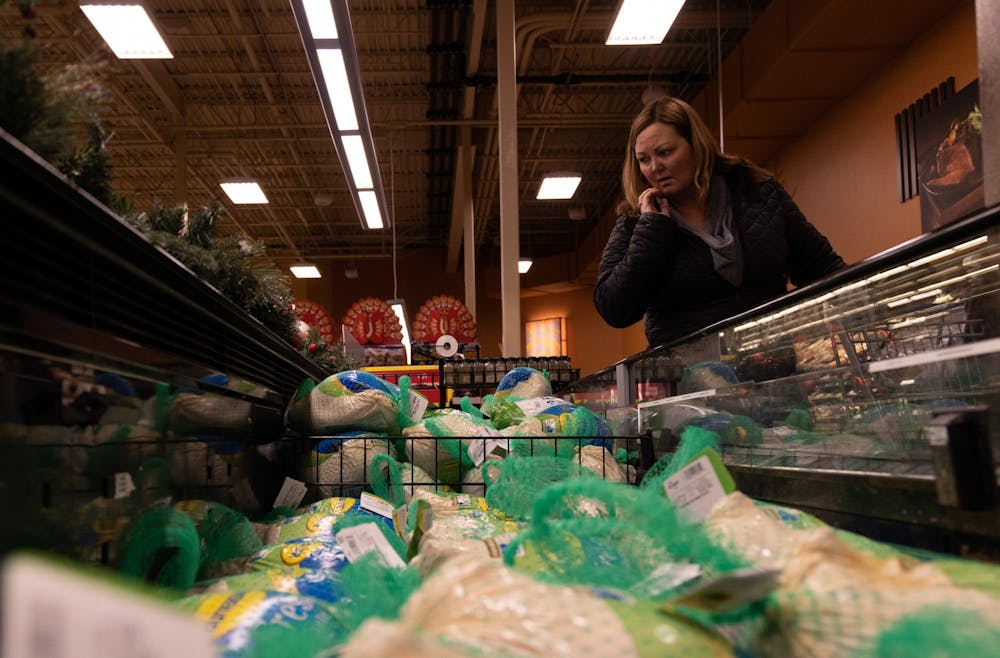 <p>Bloomington resident Shelly Bruce shops for a turkey Nov. 14, 2022, at the Kroger located at 1175 S College Mall Rd. The turkeys at Kroger were priced between $1.50 and $3.00 per pound, with some turkeys priced over $40 due to the influx of birds affected by the avian flu.</p>