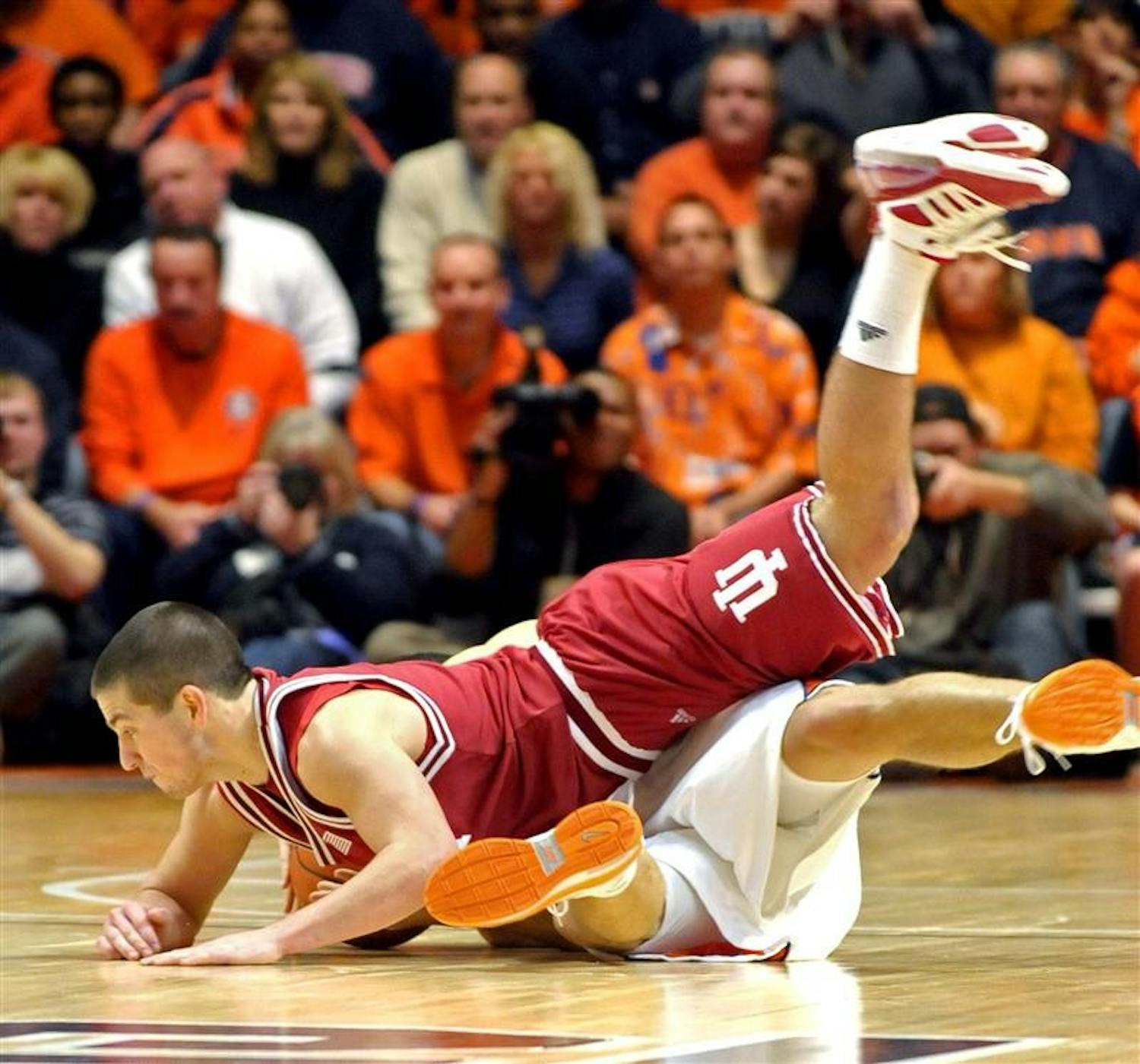 IU freshman Daniel Moore (3) pancakes Illinois' Trent Meacham (1) as he dives for a loose ball in the second half of a 76-45 IU loss in Champaign, Ill. The defeat was the Hoosiers' sixth consecutive and eighth in their last nine games.