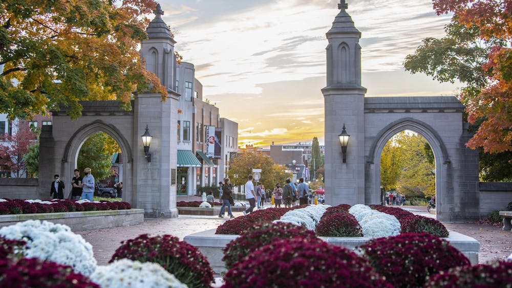 The sun sets Oct. 10, 2020, beyond the Sample Gates. IU’s Board of Trustees approved a budget of $4.2 billion for the 2023-24 fiscal year during their meeting on June 15-16.