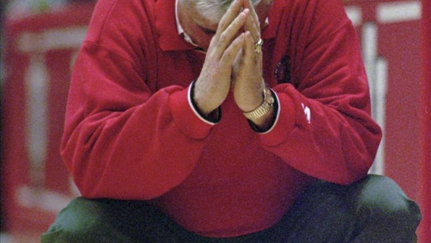 Indiana coach Bobby Knight crouches down in frustration as his team relinquishes their lead in the final minutes against Illinois, in this February 2, 1997 photo, in Bloomington, Ind.