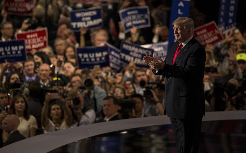Republican presidential nominee Donald Trump claps with the audience shortly after walking on stage Thursday night at the Quicken Loans Arena in Cleveland, Ohio to accept the nomination of the Republican Party for president of the United States.