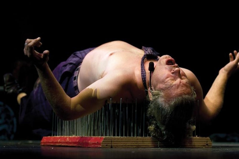 Swanky lays on a bed of nails on Friday, August 24, 2007 at the Buskirk-Chumley Theater. Swanky was one of the performers from the Blue Monkey Sideshow during the Dark Carnival Film Festival and also provided music during the sideshow.