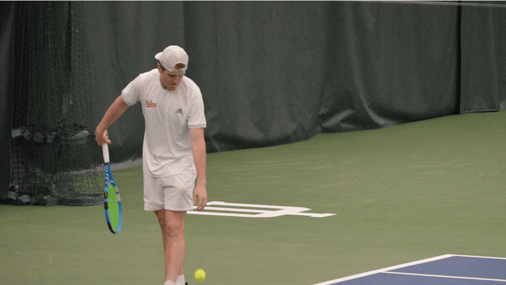 Then-junior Patrick Fletchall prepares to serve the ball on April 11, 2021, at the IU Tennis Center. Indiana will play No. 29 Vanderbilt University in its final nonconference match of the season on March 23 in Nashville, Tennessee.