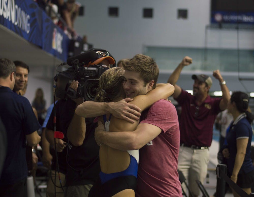 IU diver Michael Hixon hugs Katrina Young after she qualified for the Olympics in the women's 10-meter event Sunday at the IUPUI Natatorium. Hixon qualified for the Olympics in the 3-meter synchronized dive and the individual men's 3-meter event.