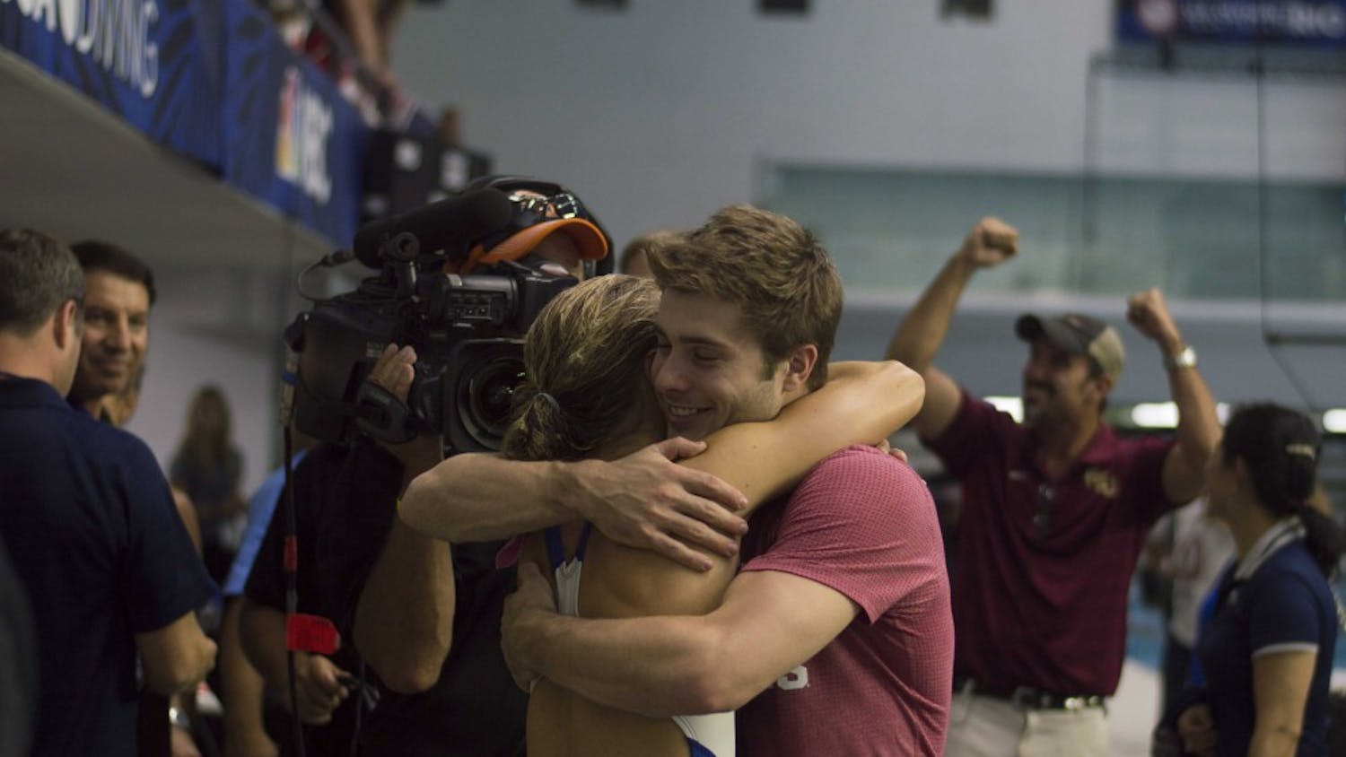 IU diver Michael Hixon hugs Katrina Young after she qualified for the Olympics in the women's 10-meter event Sunday at the IUPUI Natatorium. Hixon qualified for the Olympics in the 3-meter synchronized dive and the individual men's 3-meter event.