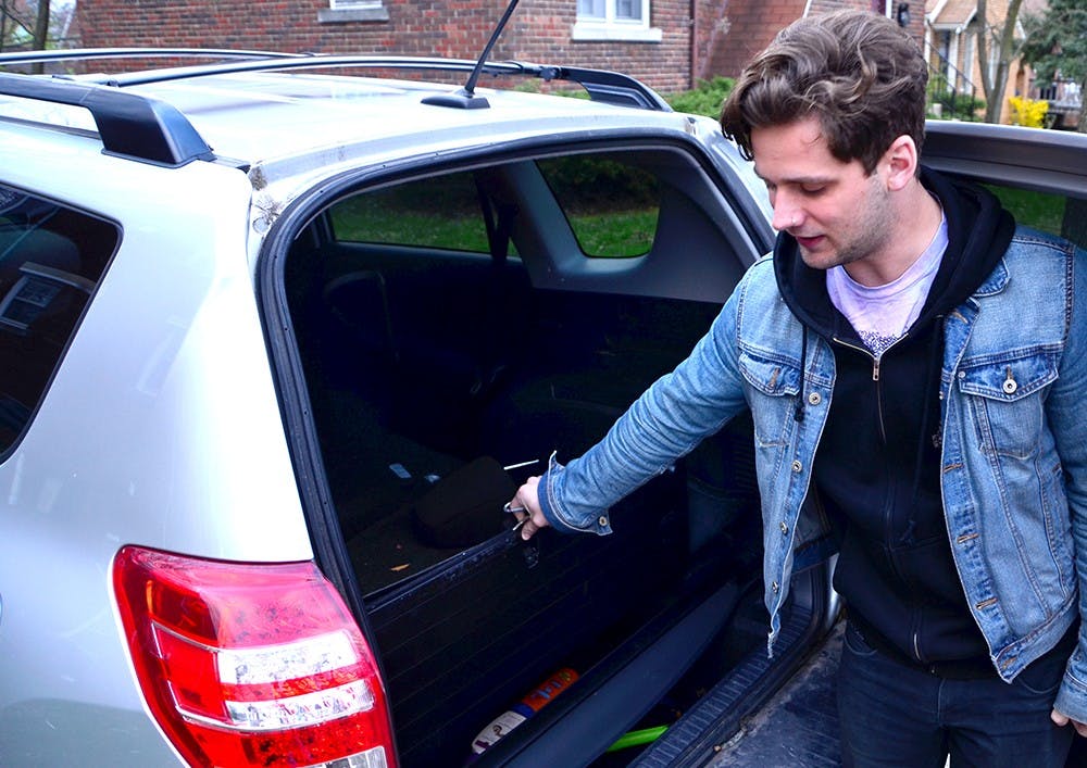 Nathan Kane, composer of the local band, Whale Bones, introduces the Toyota RAV which they drive for show tours Monday in the front of the band house on Jordan Avenue. Kane said they had to stay in the car for most of their time when they were on show tours. They have driven the SUV around two years. 