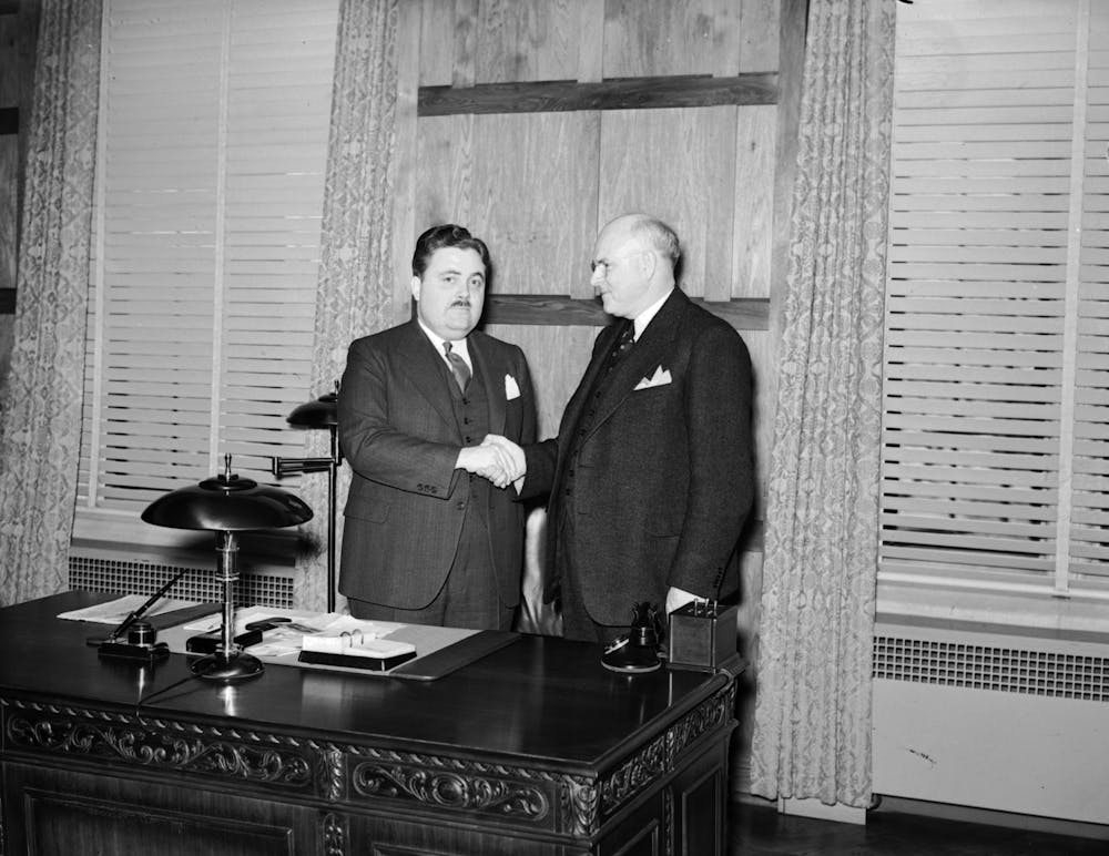 <p>Former IU President Herman B Wells shakes Ora L. Wildermuth’s hand in 1938.</p>