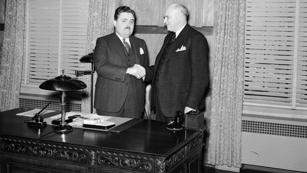 Former IU President Herman B Wells shakes Ora L. Wildermuth’s hand in 1938.