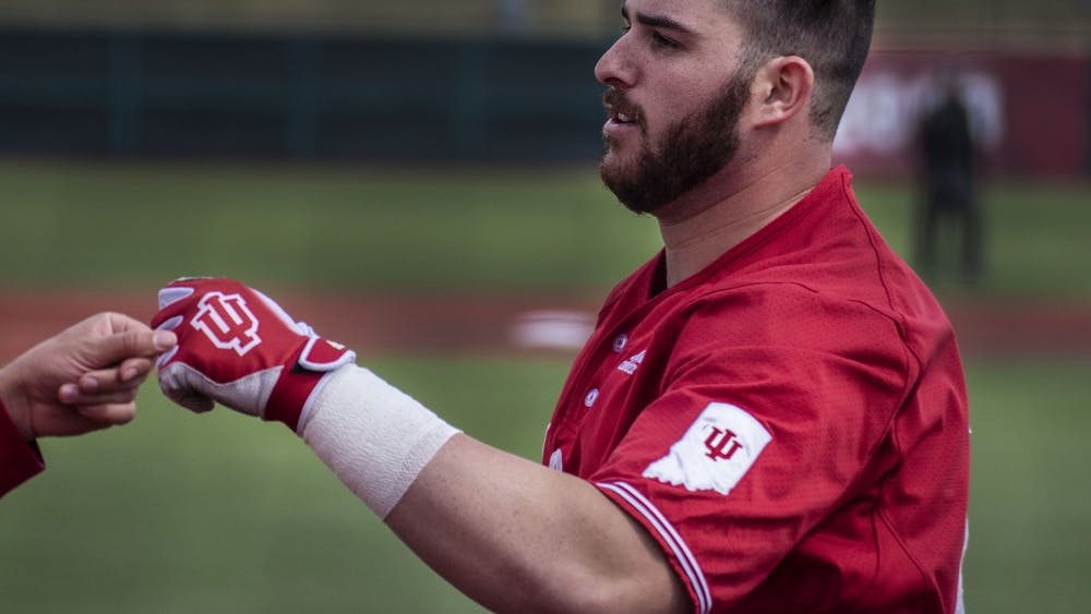 Senior catcher Ryan Fineman returns to the dugout after hitting a home run in the sixth inning against Canisius College on March 17 at Bart Kaufman Field. The Hoosiers will take on Indiana State on March 19.