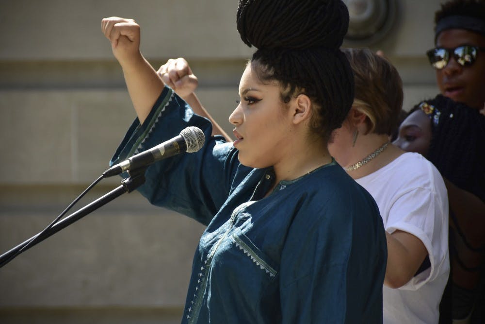 Alexis Prall asks participants to raise their fists and advocate for “all lives matter”. 