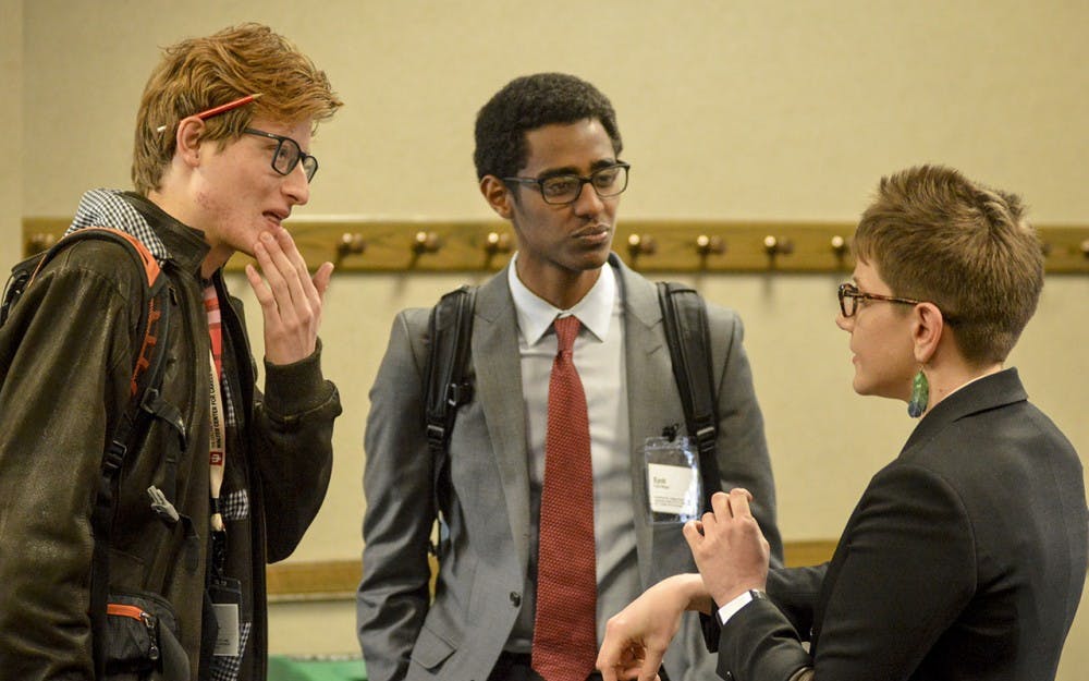 Junior Jorge Campana Perez and Sophomore Eyob Moges network with Raymond James Financial Advisor Julie Singer during the Connect 17 networking conference hosted by The Walter Center for Career Achievement Friday afternoon in the IMU Tree Suites.
