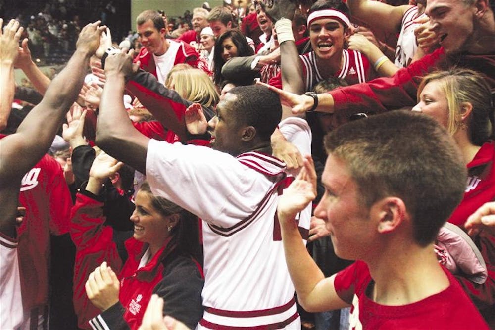 Freshman guard Nick Williams celebrates with fans following IU’s 60-57 victory against IUPUI on Tuesday at Assembly Hall.