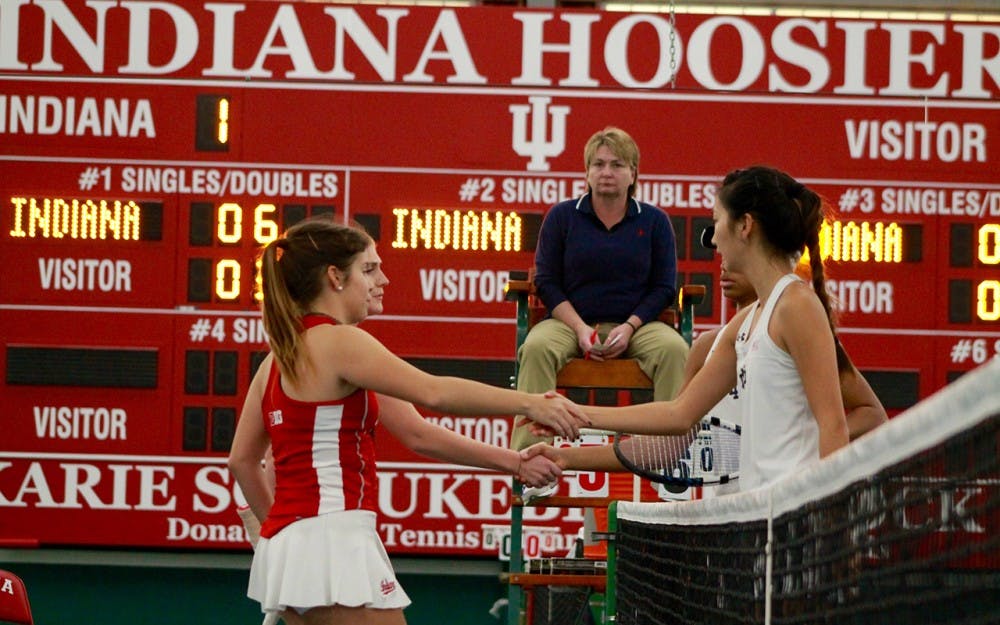 Doubles partners, senior Paula Gutierrez and freshman Pauline Jahren, shake hands with their opponents after losing in a close match to Notre Dame in February.&nbsp;