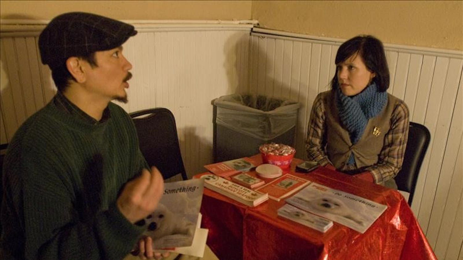 Owner of Roots restaurant Andrew Stevens and a worker for the Humane Society of United States Anne Sterling discuss the situation of seal clubbing during SEALed With A Kiss, a dance fundraiser to raise awarness of seals Saturday evening in The Lodge.